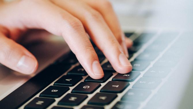 fingers on laptop keyboard