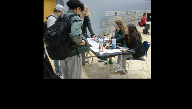 Students check in blood donors