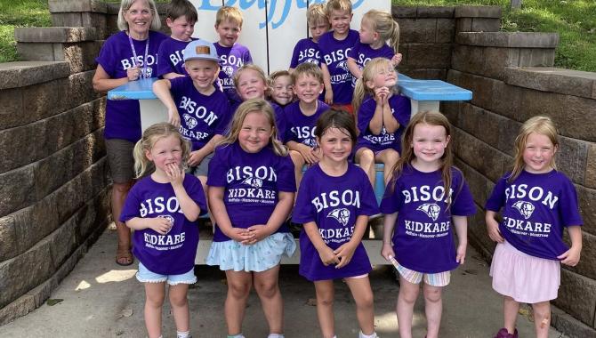 kids posing infront of Buffalo chair