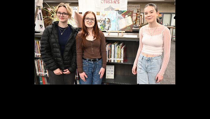 Students pose with painting