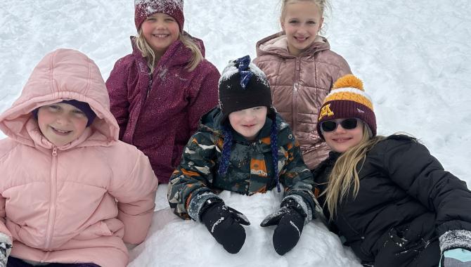 Students playing in snow