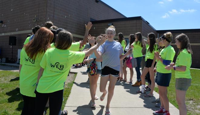 kids high-fiving each other