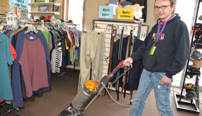 PRIDE student vacuuming