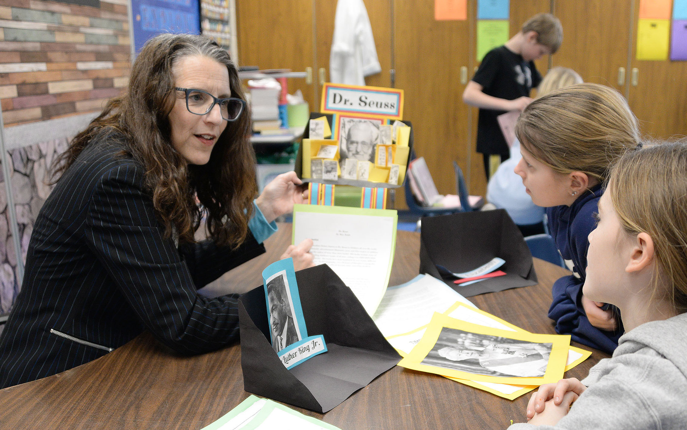 Teacher works with students