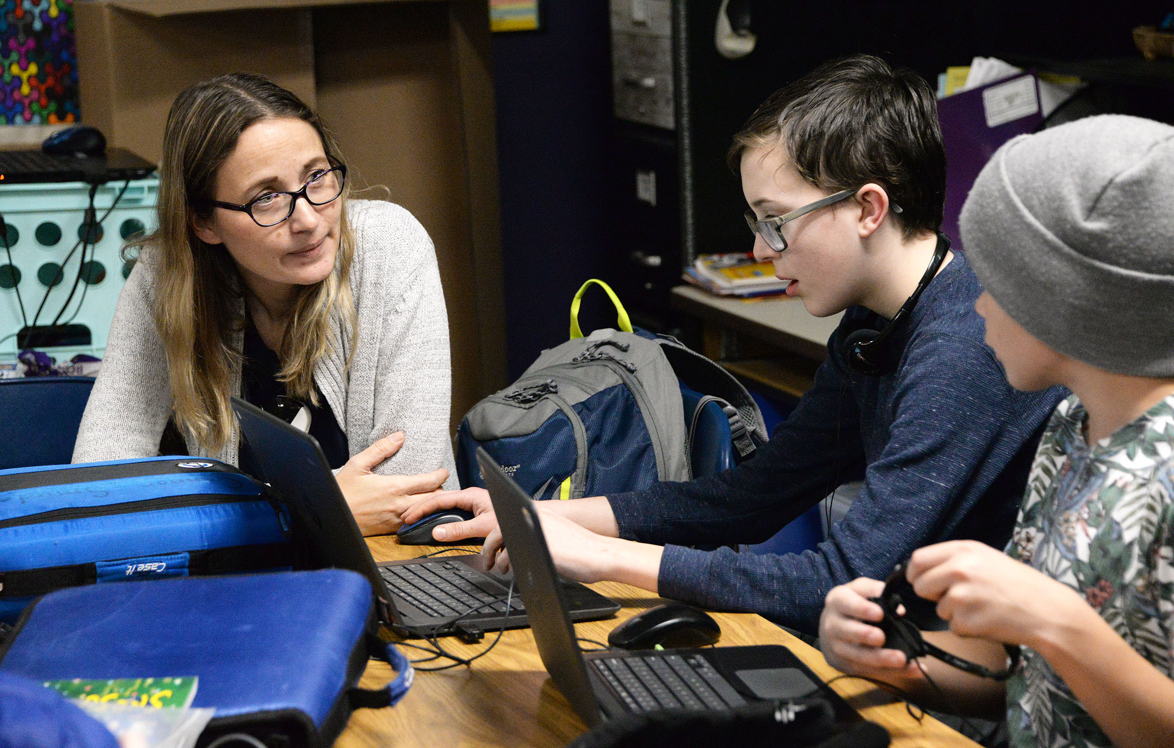 Teacher works with students