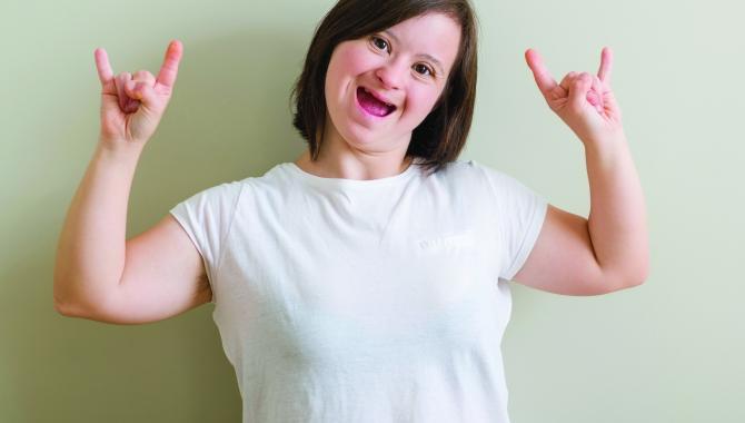 Adult with disability showing thumbs up