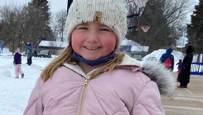 Student wearing winter hat and coat