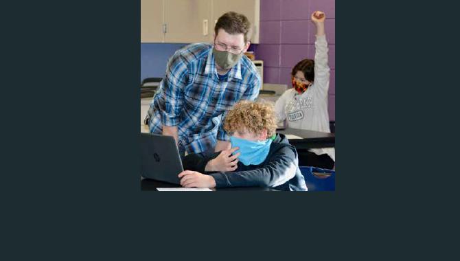 teacher helping student