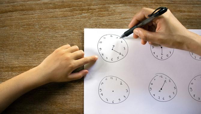 student and teacher drawing clocks