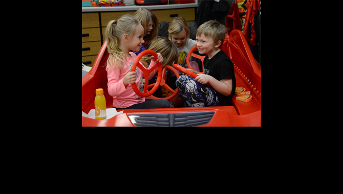 Students play in toy car