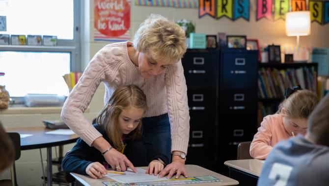 Teacher helping student