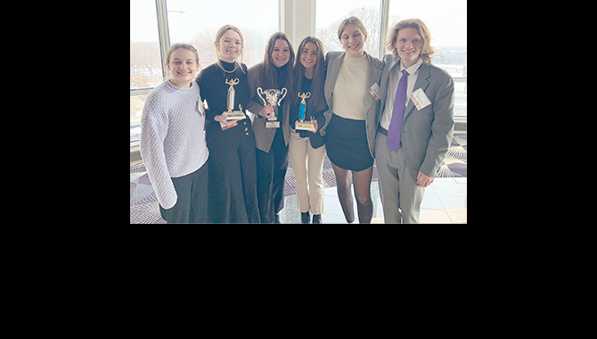 Mock trial team members with trophies