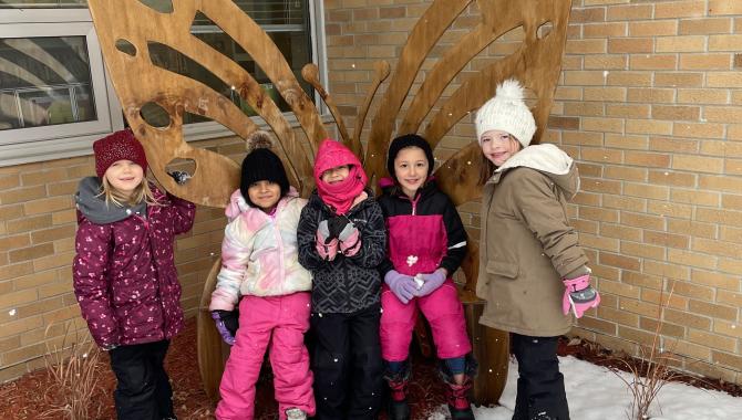 Students outside with coats and hats.