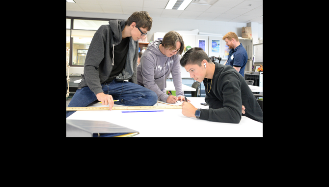 Students studying with teacher