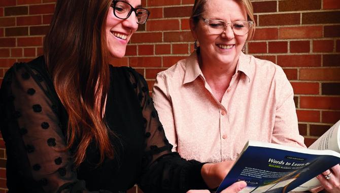 Two teachers discussing lesson plans