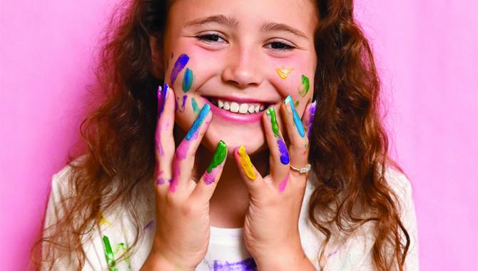 Elementary student with paint