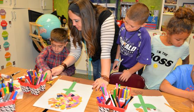 Teacher with students doing art projects