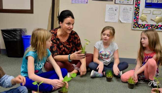 Discovery teacher with students discussing plants