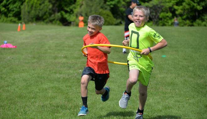 boys running outside in a hoop