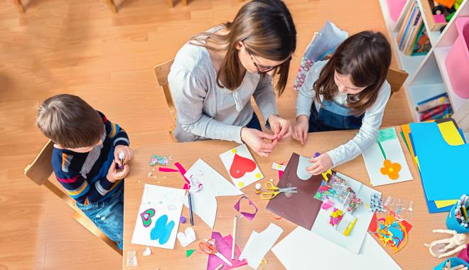 parent working on an art project with kids