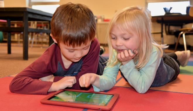 kindergarten students on a tablet