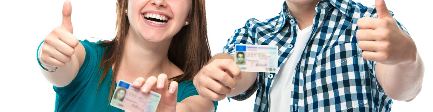 Two high school students showing their drivers license