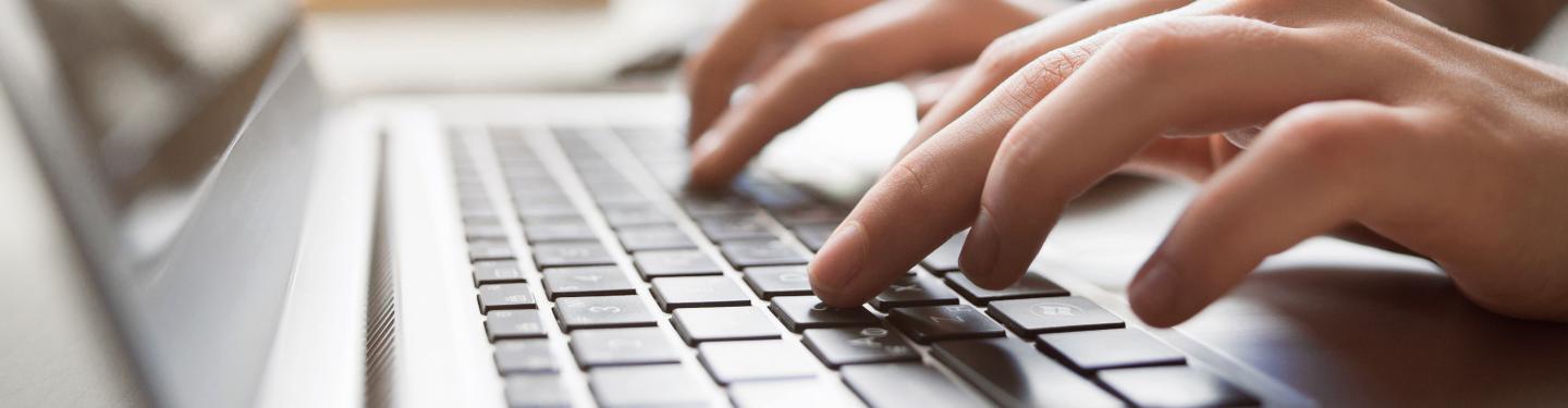 student at a computer typing