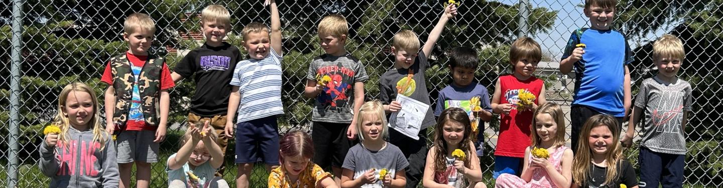 Students outside collecting dandelions