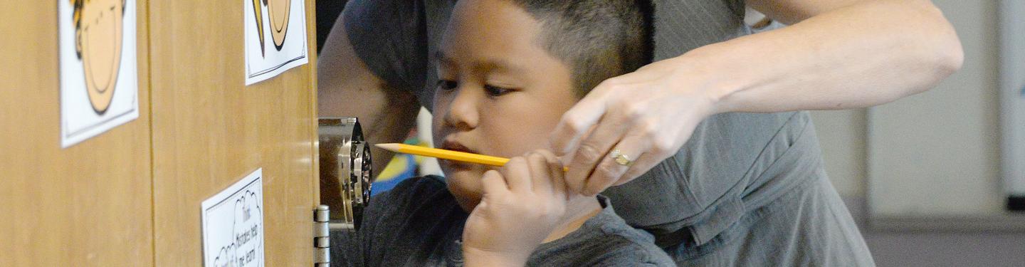 Student sharpening pencil