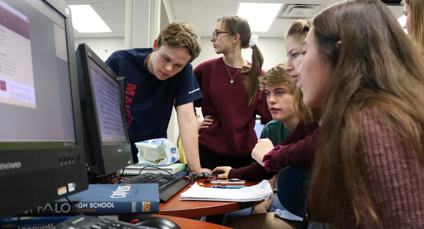 Students in a group at computer