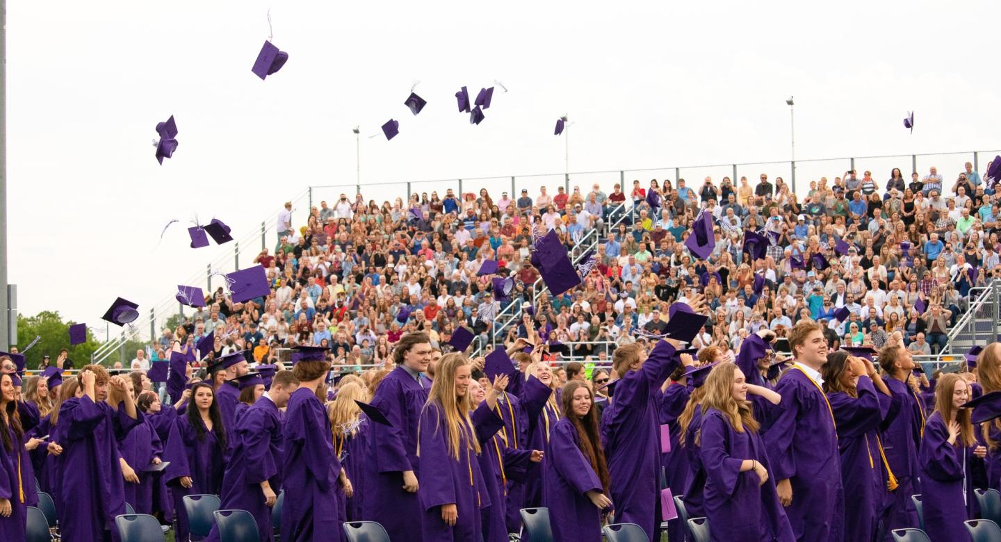 Graduates toss their caps