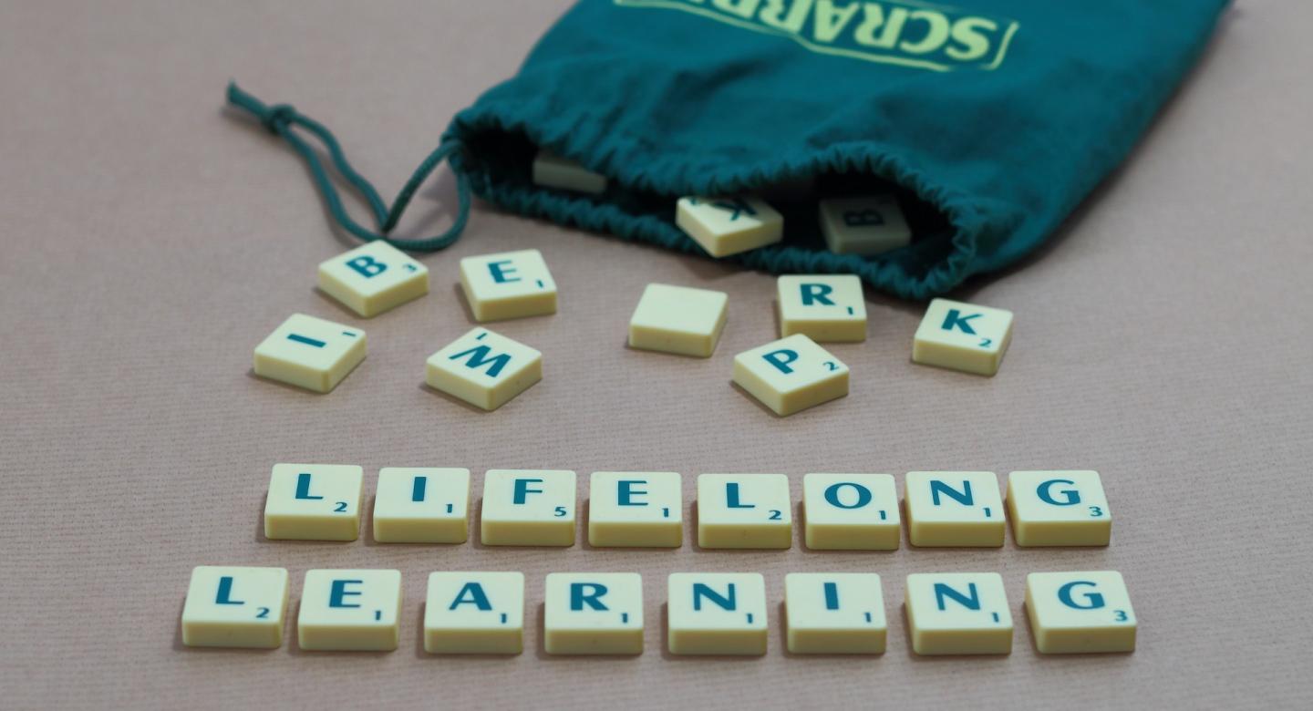 bag of scrabble letters spelling out lifelong learning