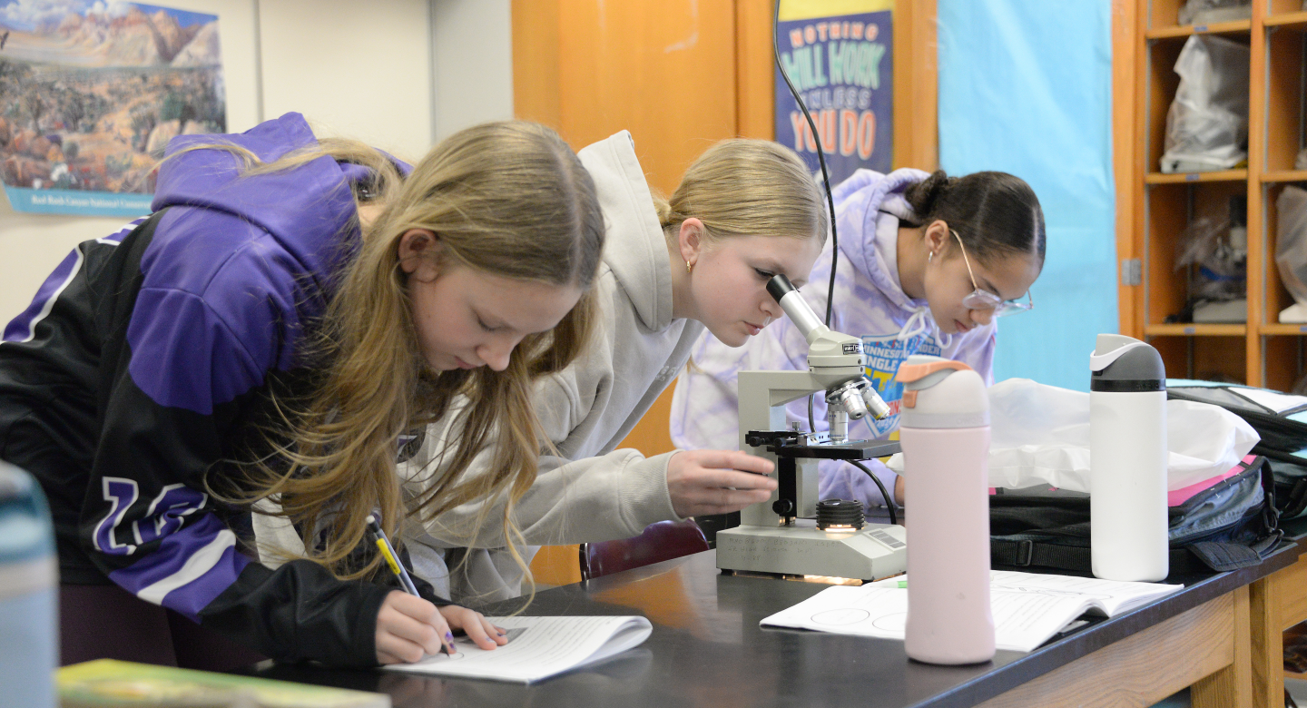 Students looking into microscopes