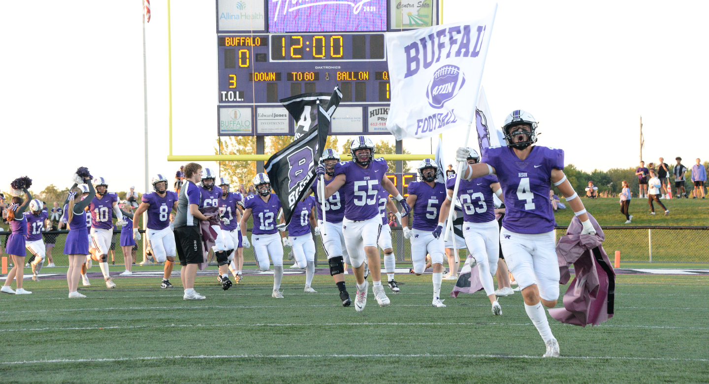 Football players carrying flags