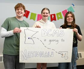 Students hold a nationals banner