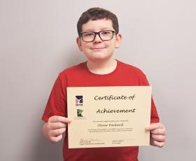 Student holding certificate