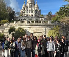 Students pose in front of the Sacré Coeur basilica
