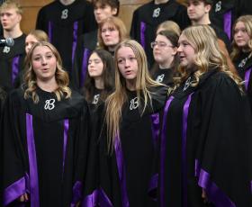Concert choir members singing