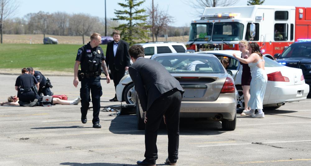 An impaired driver reacts to the mock crash scene.