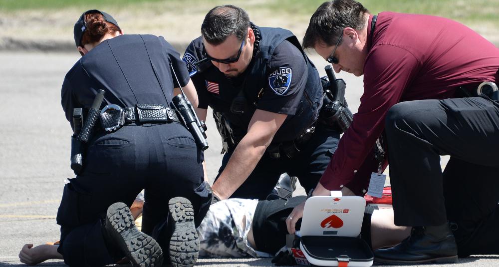 Emergency personnel tend to a mock crash victim.