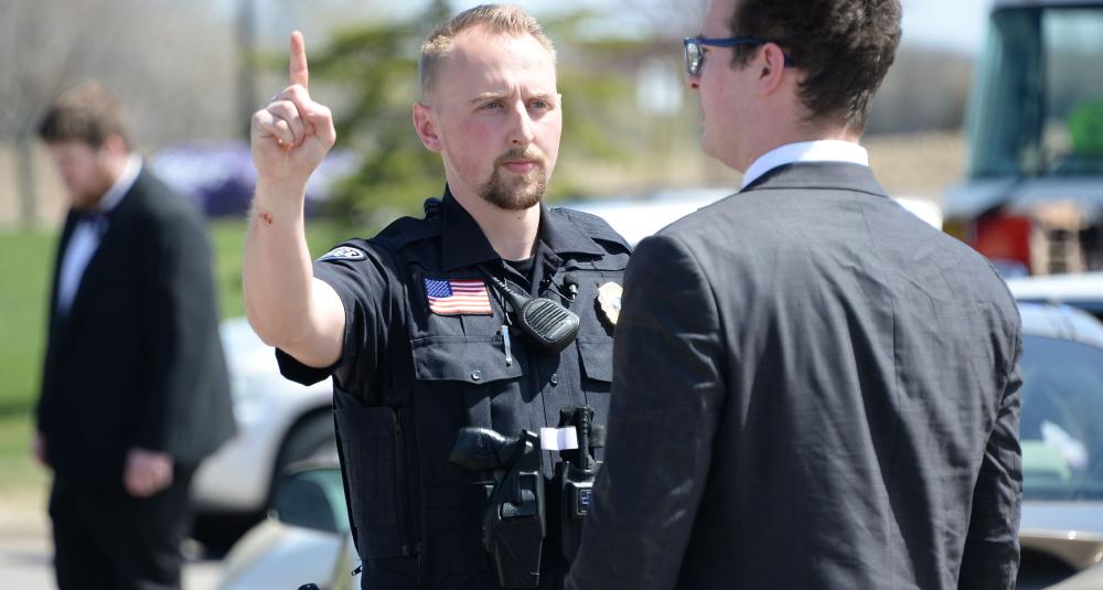 A police officer conducts tests to see if a driver is impaired.