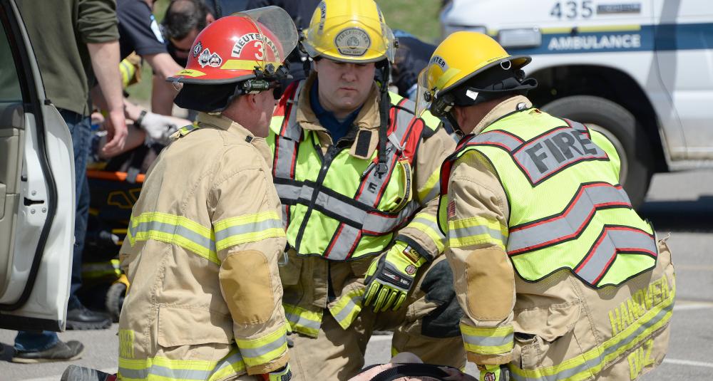 Firefighters tend to a mock crash victim.