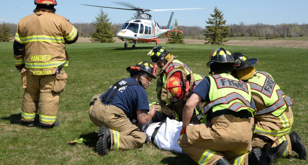 Firefighters prepare to move a mock crash victim to a North Memorial helicopter.
