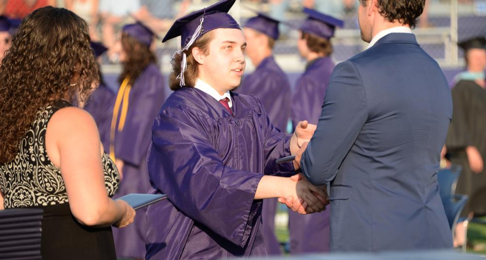 Graduate receives diploma