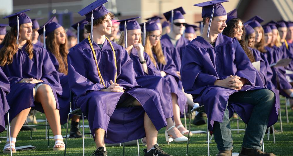 Graduates listen to a speaker