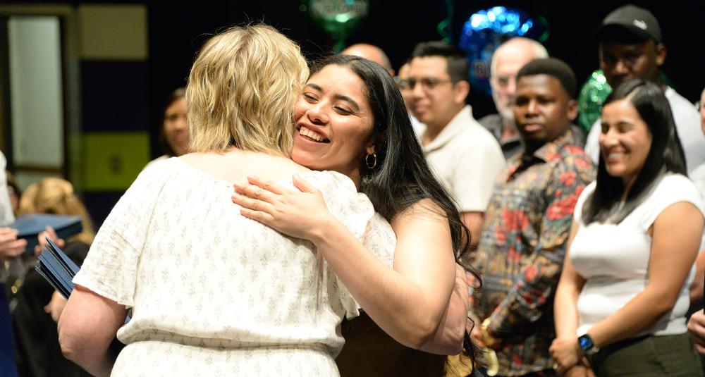 Student hugs teacher